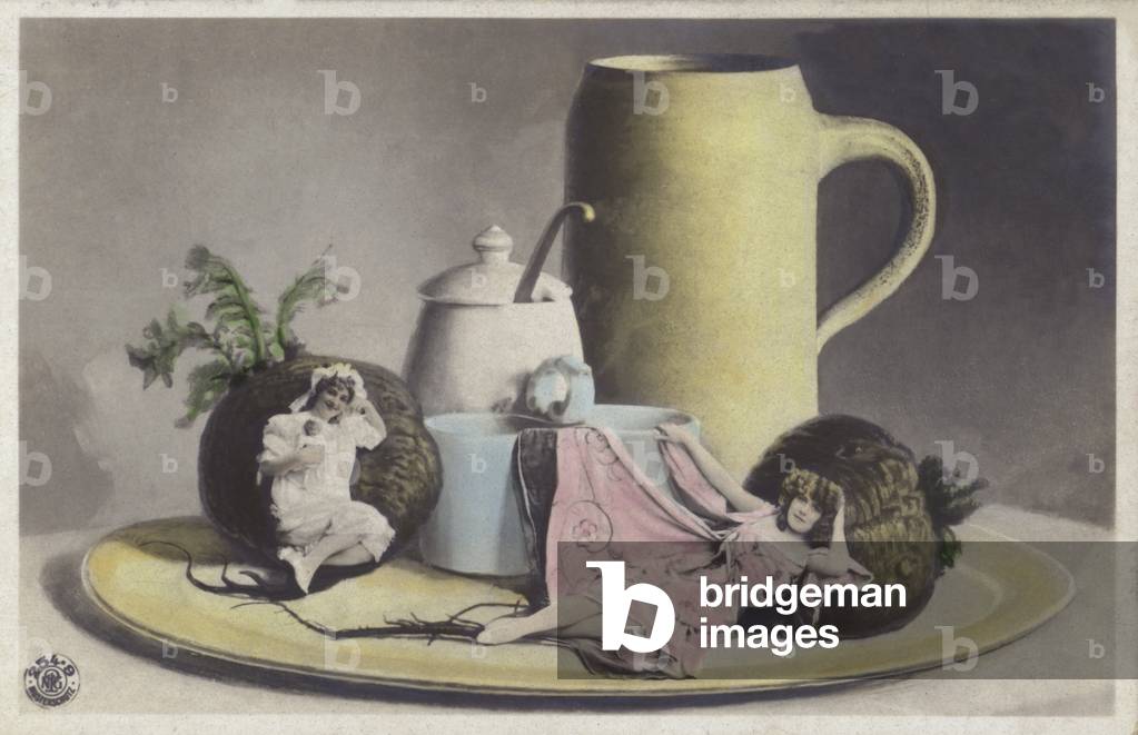 Tiny girls on a tray of crockery (colour photo)