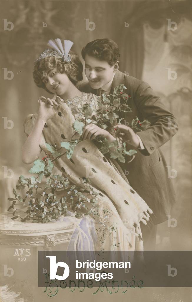 Happy New Year greetings card with romantic couple holding mistletoe, 1913 (hand-coloured photograph)
