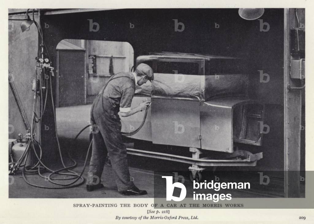 Spray-painting the body of a car at the Morris Works (b/w photo)