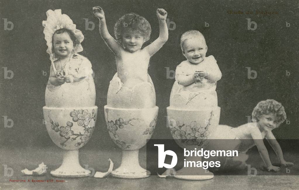 Babies hatching from eggs in eggcups (b/w photo)