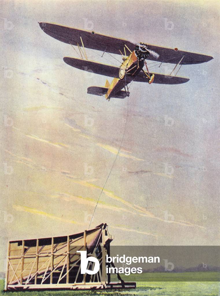 An aeroplane picking up mails while in full flight (colour photo)