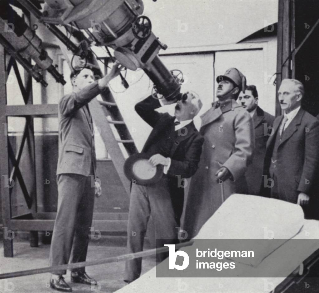 Sir Frank Dyson, when Astronomer Royal, demonstrating one of the great telescopes at Greenwich Observatory to ex-king Amanullah (b/w photo)