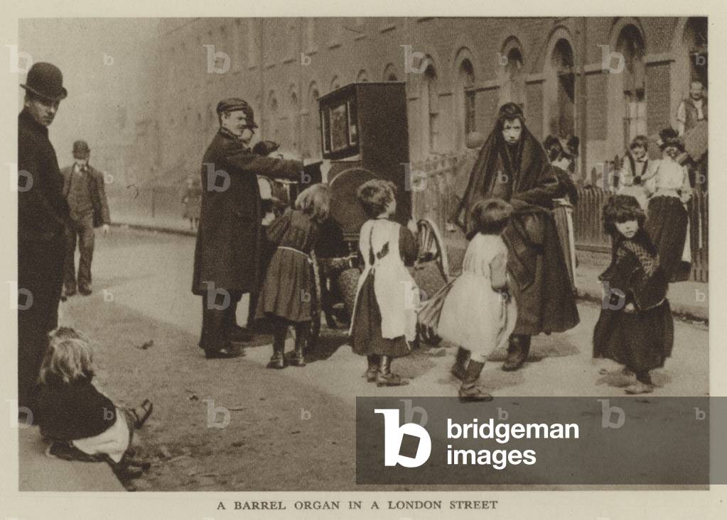 A Barrel Organ in a London Street (b/w photo)