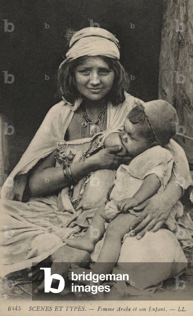 Arab woman feeding her baby (b/w photo)