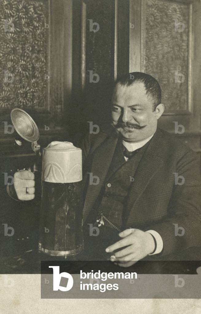 Man drinks huge stout (b/w photo)