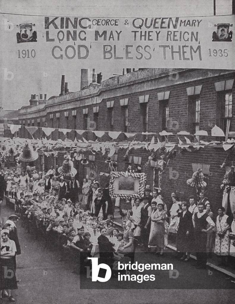 Street tea party for poor children in Palace Road in London's East End, in commemoration of the Silver Jubilee of King George V, 1935 (b/w photo)