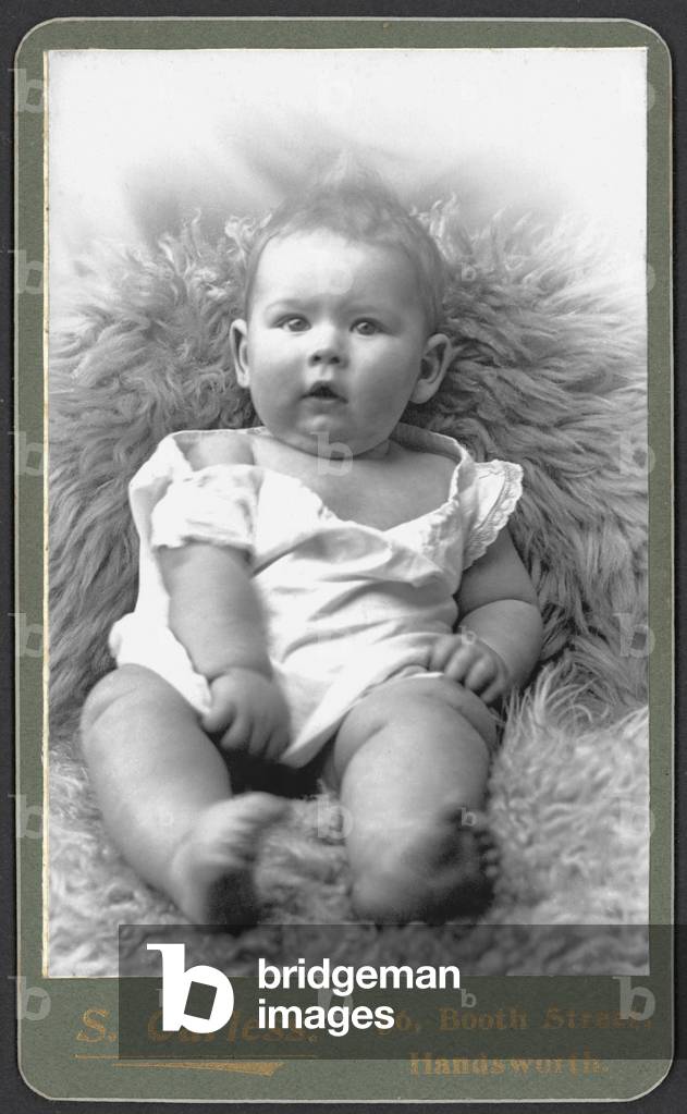 Baby lying on a sheepskin (b/w photo)