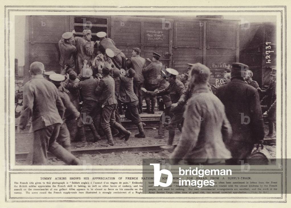 Tommy Atkins shows his appreciation of French rations, scrumming for bread from a supply-train (b/w photo)