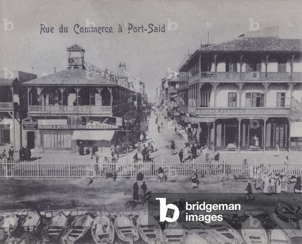 Street with shops in Port Said, Egypt (b/w photo)