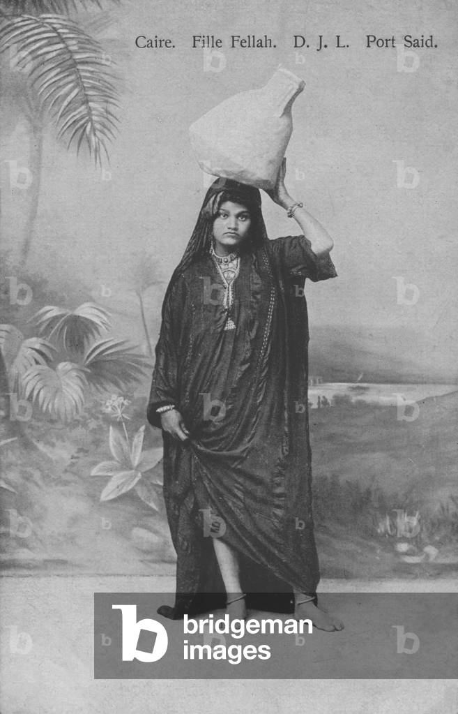 Young peasant girl (Fellah) carrying water, Port Said, Egypt (b/w photo)