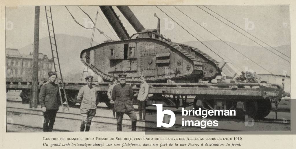 British tank sent to the White Russian army being loaded onto a train for the front after arriving at a port on the Black Sea, Russian Civil War (b/w photo)