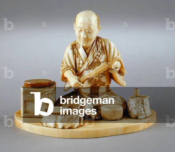 A fan-maker seated with his equipment, Japanese, 19th century (ivory)