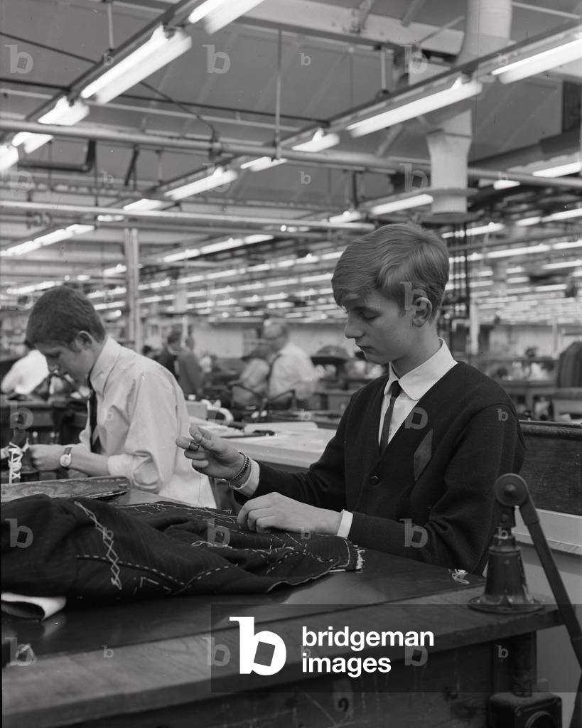 Young tailor at work, Burton's tailors, England, 1966 (b/w photo)