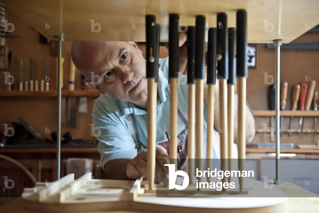 Master Luthier (Guitar-Maker)  making a classical Spanish guitar