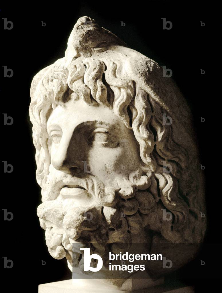 Roman art: “” bearded head covered by a dead bird of Sarapis or Serapis, Greek-Egyptian god of Death””” Marble sculpture from Carthage. 2nd century. Dim. 60 cm Paris, Musee du Louvre