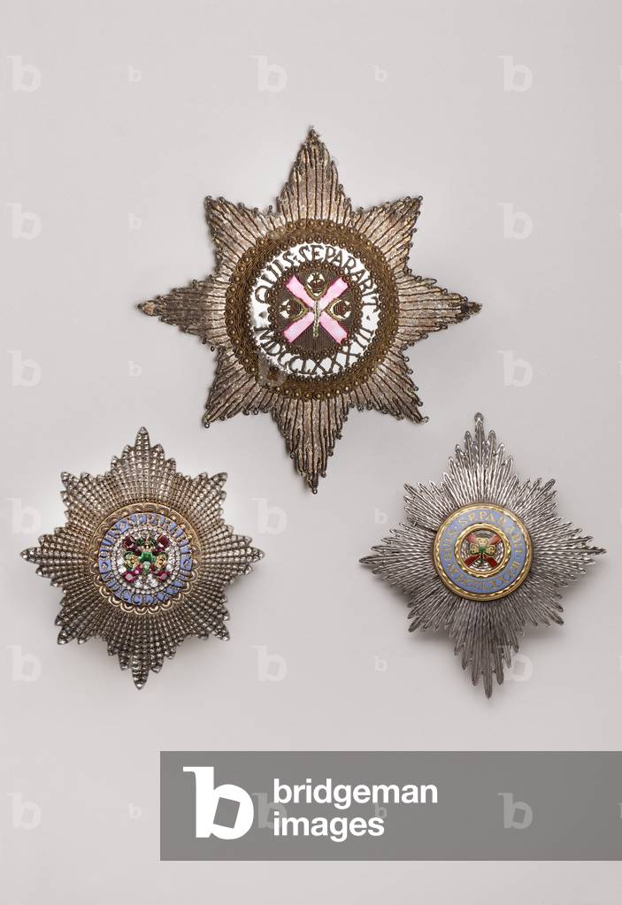 United Kingdom - Order of St. Patrick - Top: plate, End of XVIII century, Embroidery with silver and silk thread, metal beads, tinsel, crantilla and sequins, H 14 cm; w 13,4 cm; weight: 20 g - Left: plate, made by West & Son (Dublin), End of XIX century, Gold and silver and diamonds and rubies and emerald and emals, H 9,4 cm; width 8.7 cm; weight: 100 g - Right: plate, End of XIX century-beginning XX century, Gold and silver and enamels, H 11 cm; w 9.2 cm; weight: 60 g - Private collection