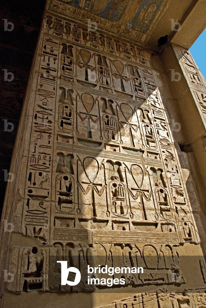 Egyptian antiquite: first court, reliefs of the east colonnade. Funeral Temple of Ramses III (1187-1156 BC). Luxor, Medinet Habou, Egypt