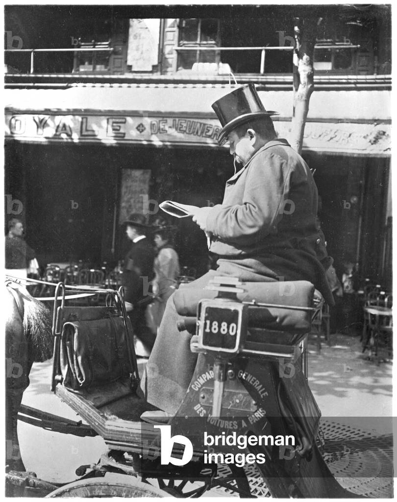 Parisian cabman reading his newspaper, c.1900 (b/w photo)