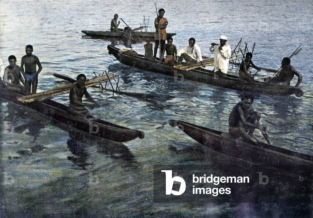 Papua men on the canoes (New Guinee).