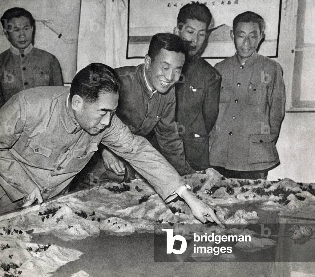 Zhou Enlai (or Chou En-Lai (En Lai) or Cheou Ngen-lai (Ngen lai) or Chu En Lai) (1898-1976) examining the model of the new Pekin water reservoir in 1959. Photography, in “The Life of Zhou En Lai”, Shanghai, 1977.