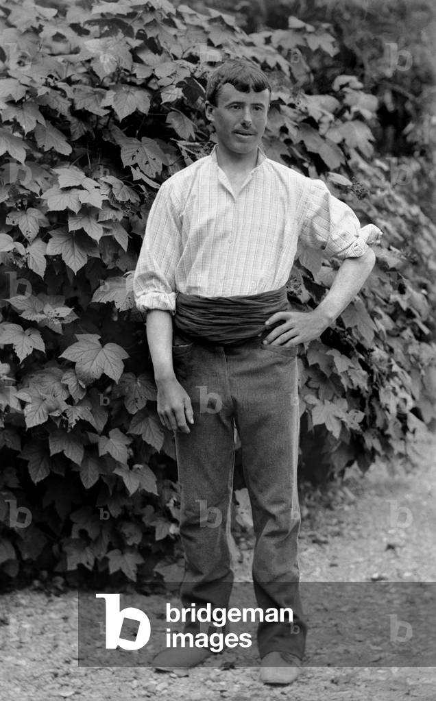 Young man employed as a man to do everything, posing in the garden of the Abbey of Septfontaines, near Bourmont in Haute-Marne (Haute Marne), around 1880. Photography. Ducos Collection.