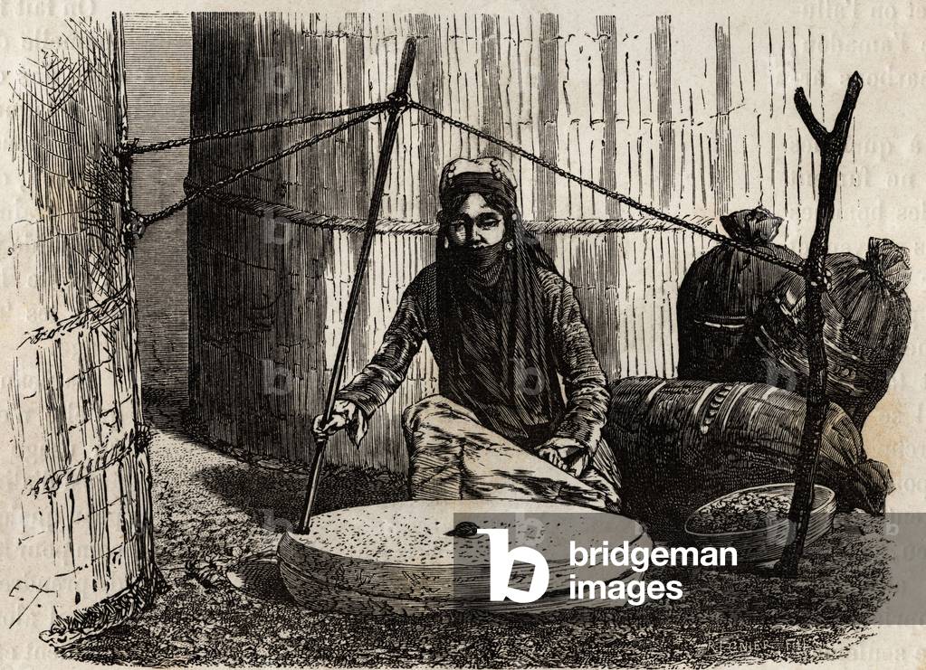 Turcoman woman using the grain grinding wheel, activating an ingenious crank system, the upper stone turns and rubbing this stone on the other crushes the grains, which make up the basis of the turcoman diet, in the form of bread, boiled, patties. Engraving to illustrate the story of Henri de Blocqueville “14 mois de captivite chez les turcomans”” between 1860 and 1861, in “Le tour du monde, nouveau journal des voyages”” published under the direction of Edouard Charton, 1866, Paris. Selva Collection.