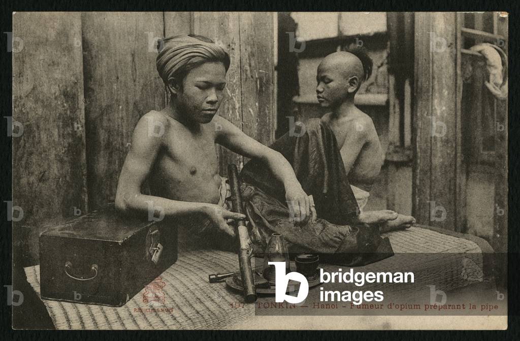 Postcard depicting an opium smoker preparing the pipe, Tonkin, Hanoi, c.1900 (b/w photo)