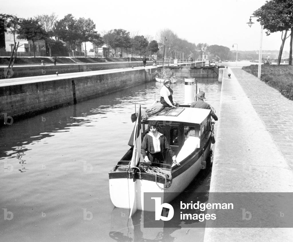 France: A houseboat arrives at a lock, 1925