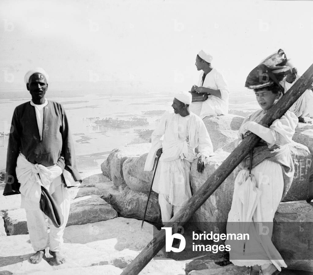 Egypt, Cairo: cruise on the Nile, tourists accompanied by their local guides are served the tea on the top of the Pyramid Cheops, flooded Nile Valley, 1900