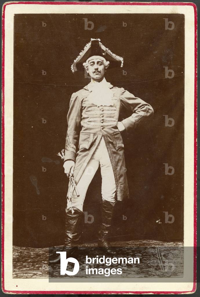 A comedian in stage dress poses in studio, 1875