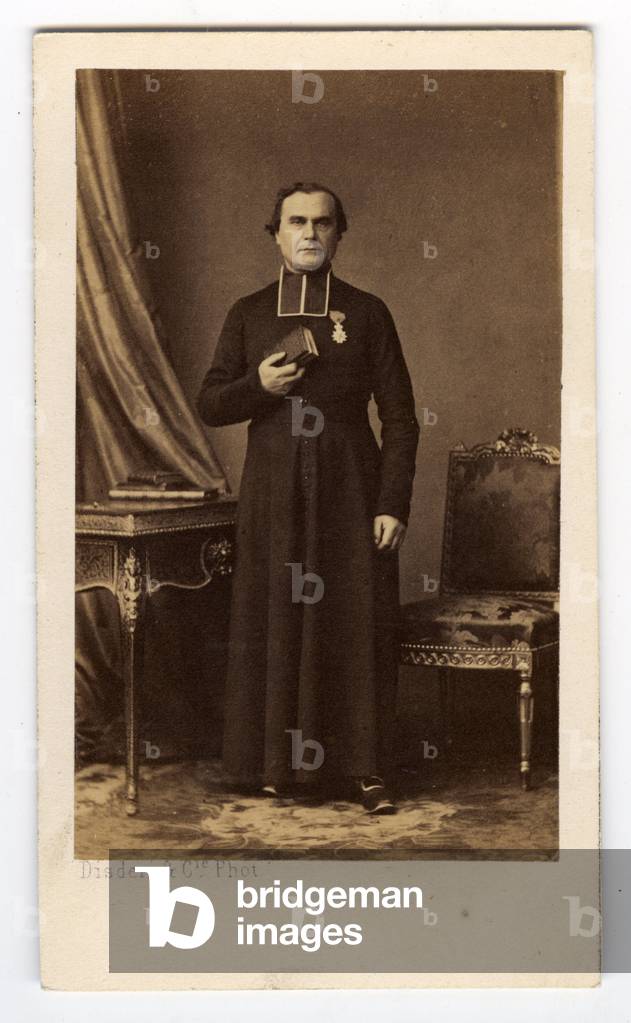 France, Studio portrait of a priest in sarcedotal clothing with a military medal, 1865