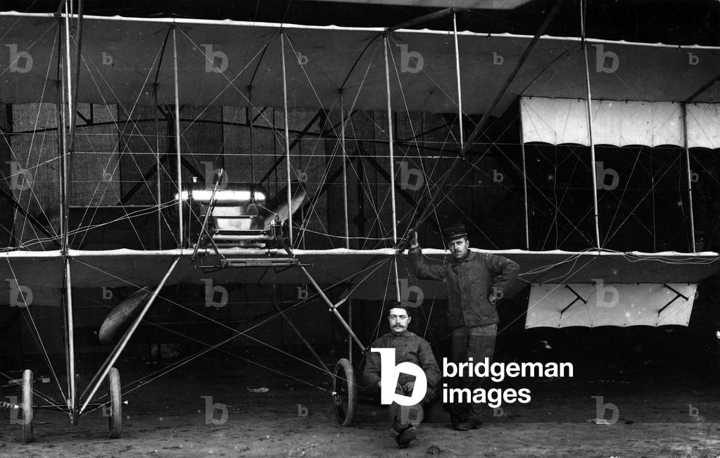 France: Two soldiers pose in front of their Farman biplane, 1910