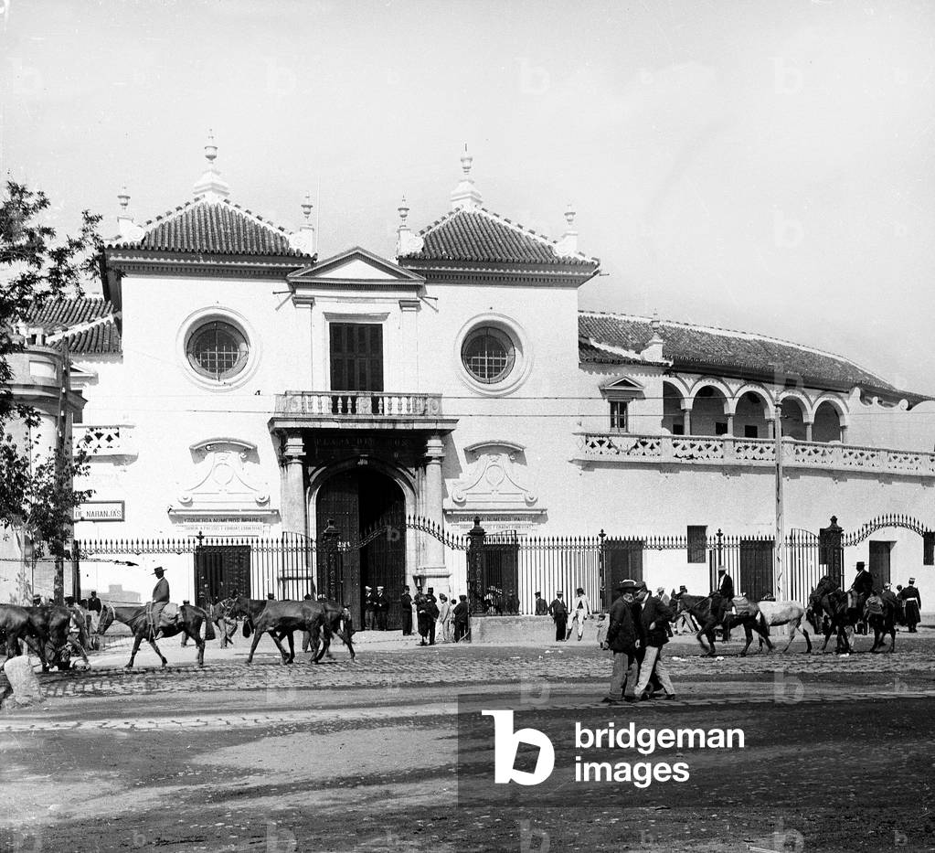 Spain, Andalusia, PR, Seville: entrance of the arenes “” plazza de toros””, in the street, many Spaniards with Andalusian hat, on horseback, 1890