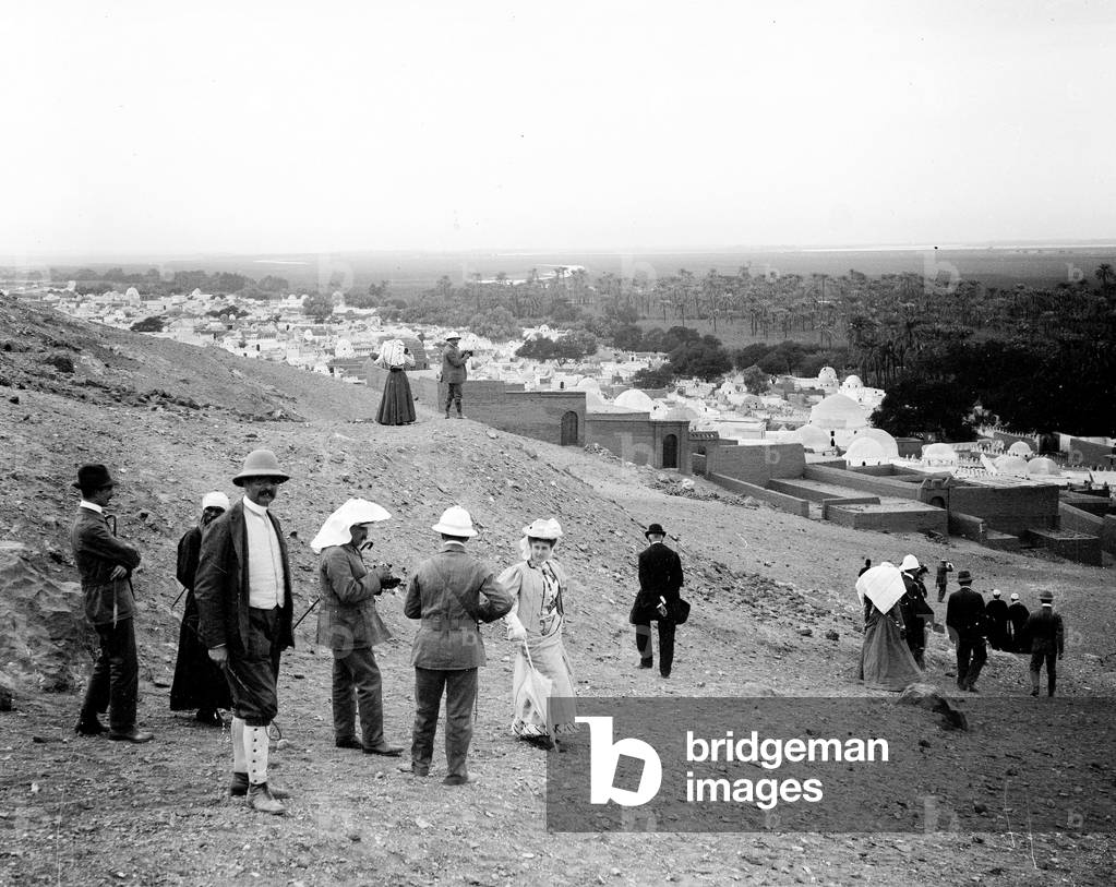 Egypt, Upper Egypt, Aswan: Cook cruise, climbing the foothills of the pyramid overlooking the cemetery of Beni Hassan with many domes and an oasis, 1900