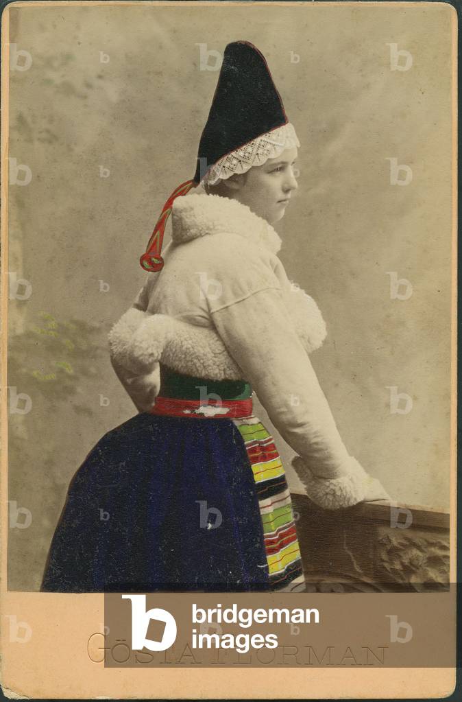 Colorful photography of a Swedish woman in professional dress in a studio, 1870
