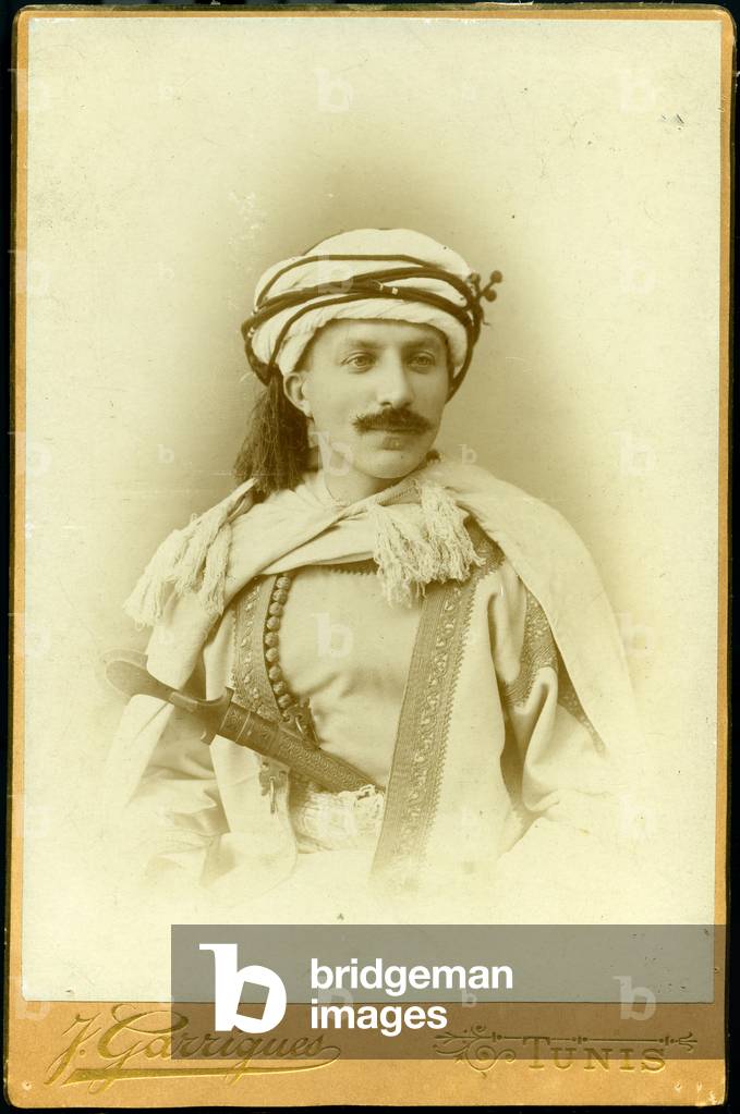 Tunis: portrait of a European dresses in local costume with chechia and burnous, 1895