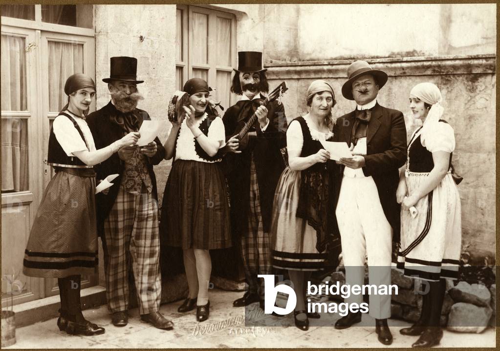 Syrian Arab Republic, Aleppo: Photo of a group of actor and actress disguises as street singer masks, 1925
