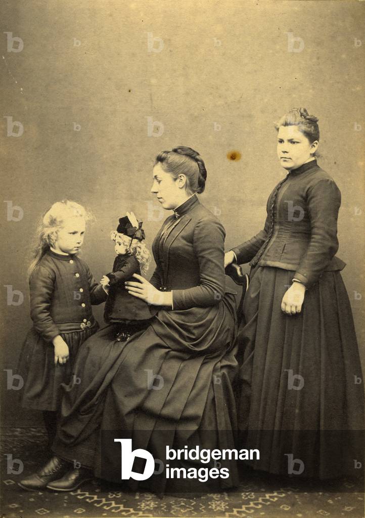 France: a mother and her two daughters with a doll, 1880