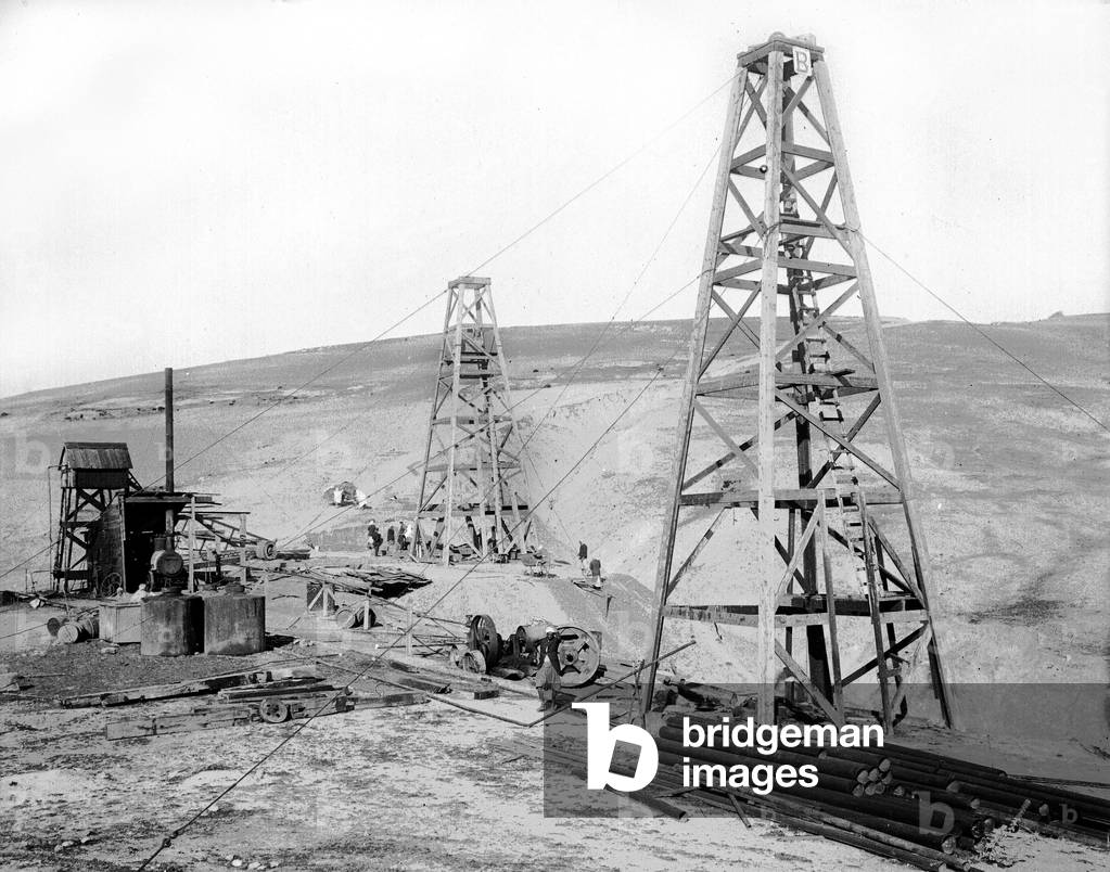Algeria, Ain Zeft: setting up the operation of an oil field with derricks under construction and various equipment including a steam machine, 1906