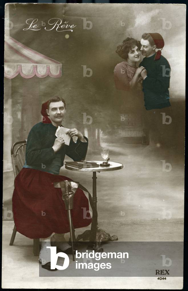 First World War: France, An Algerian Zouave reading a letter of his fiance sitting at a bistro table near the front, 1915