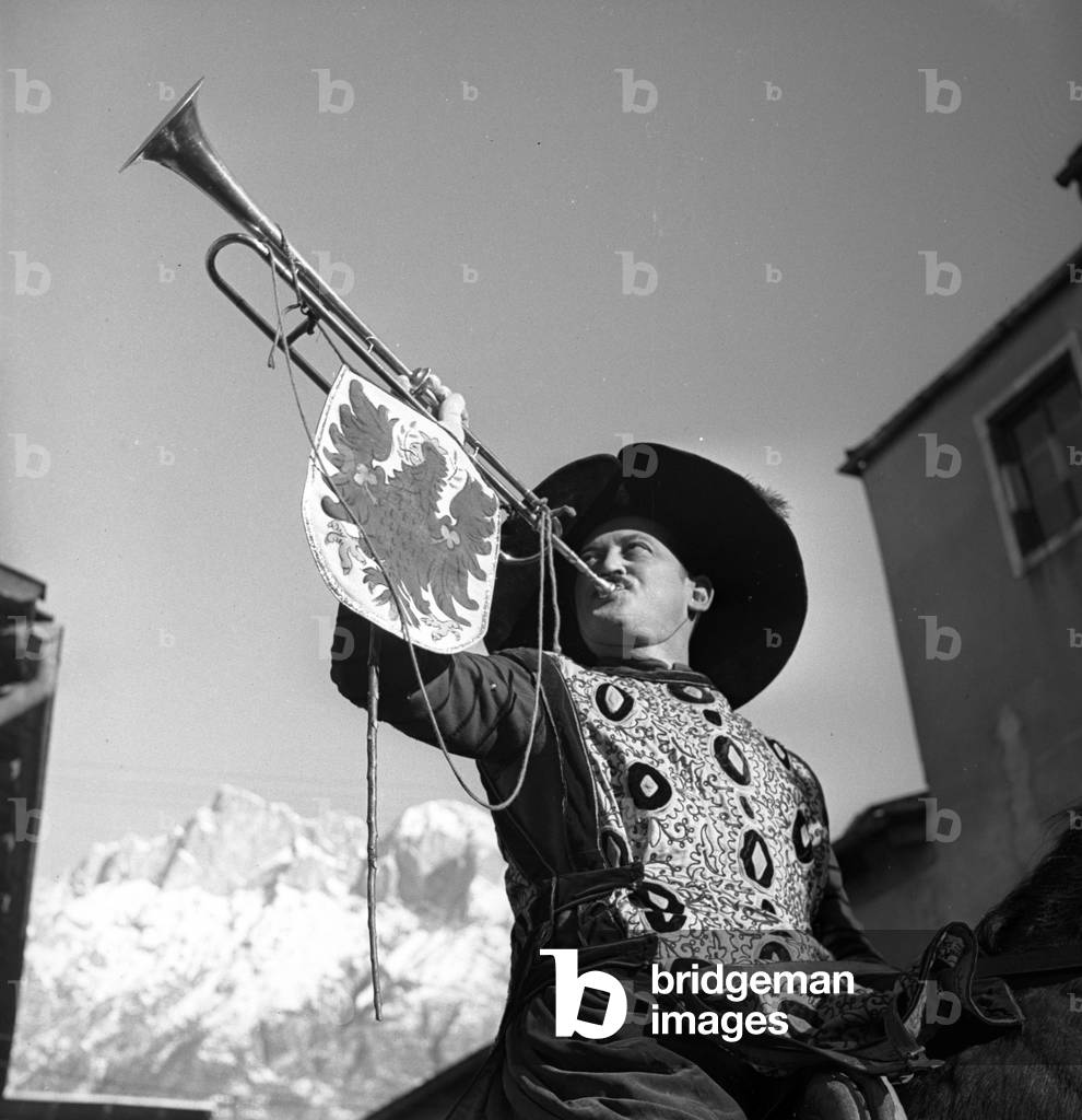 Innsbruck: A rider disguise in heraut with his trumpet and traditional costume, 1937
