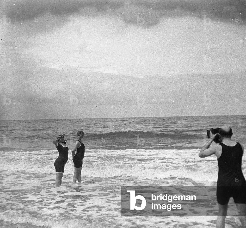 France, Lower Normandy, Calvados (14), Trouville: The beach, a man photographed two women in swimsuit in the sea, 1900