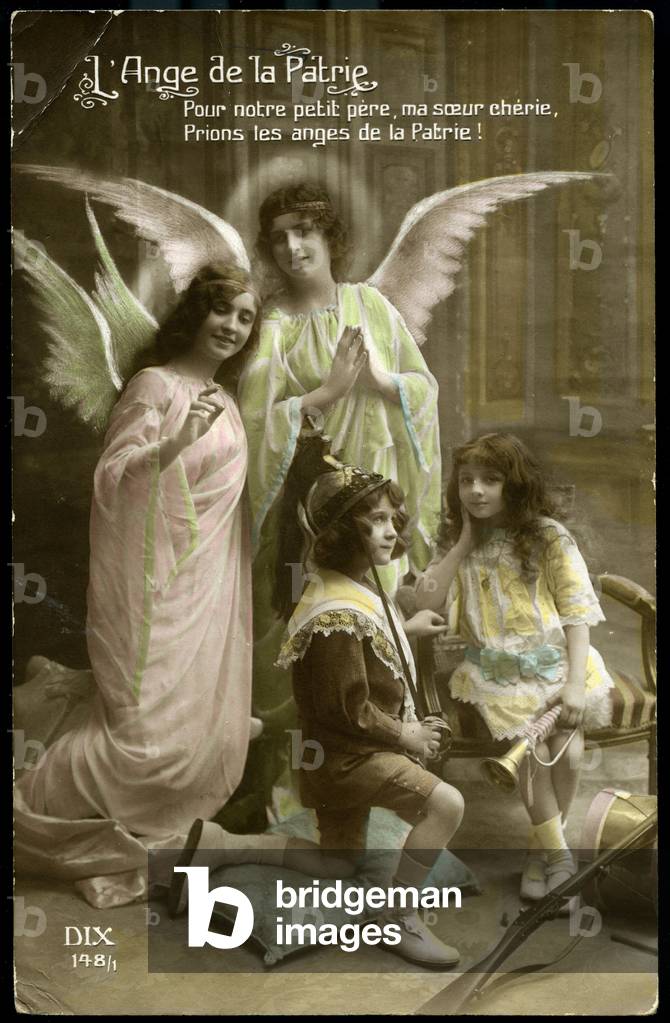 First World War: France, Postcard of a studio photograph showing two angels watching over children playing war titled “The Angel of the Fatherland””, 1915, For our little father, my dear sister, let's pray the angels of the Fatherland