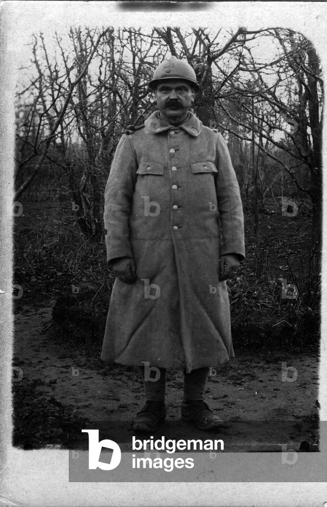 France: Portrait of a soldier in a hood and helmet, 1916