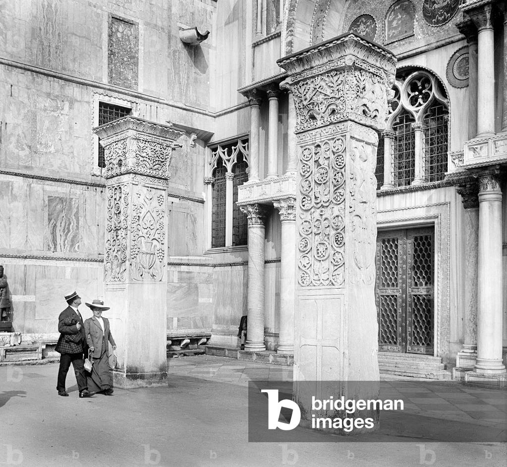 Italy, Venetie, Venice: Basilica of St. Mark, details contemplated by two tourists, 1895