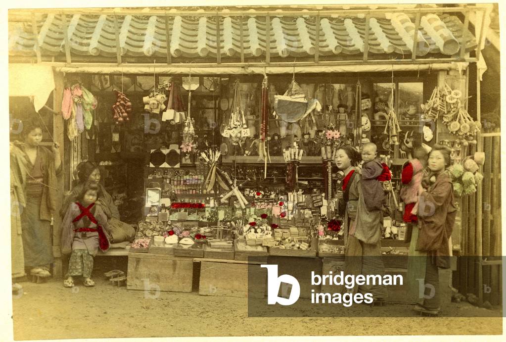 Japan: a bazaar with women and their children in front, 1875 - albumin paper enhances watercolor