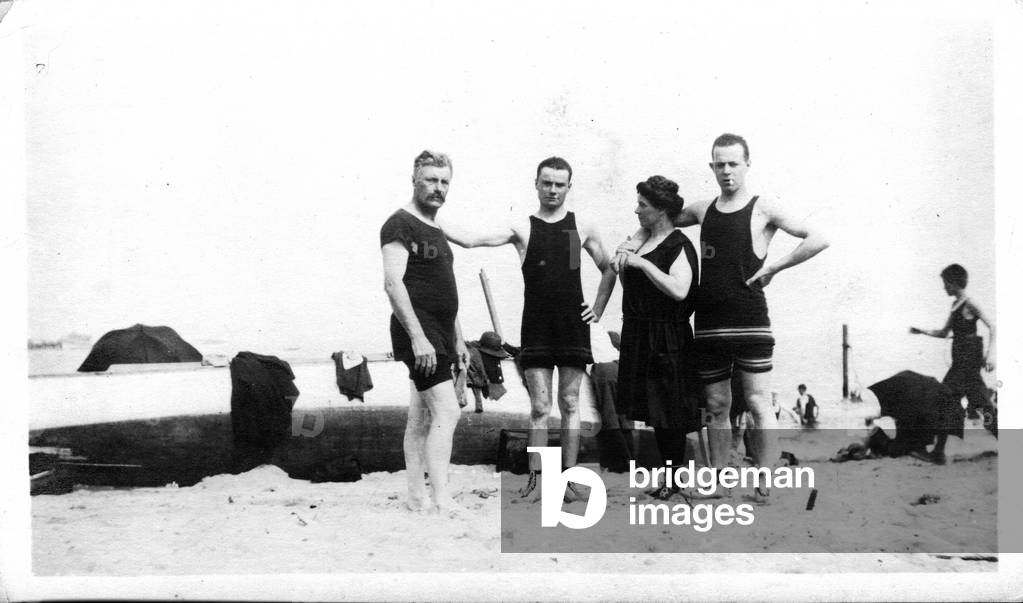 New York, USA: Three men and one woman pose on Midland Beach, 1905