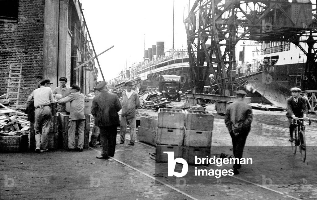 France, Haute-Normandie, Seine-Maritime (76), Le Havre: the merchant port with a quay of the transatlantic, one of which has 4 chiminees, with on the dock, cranes, trucks and goods, 1935 - transport Lucien Vaux - liner France