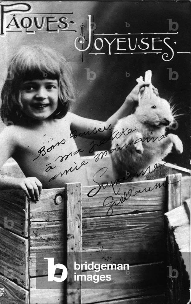 France, Ile-de-France, Paris (75): Easter fantasy photo depicting a child holding a rabbit by the ears, 1903