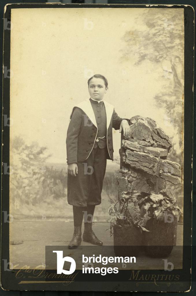 Studio portrait of a child in school uniform, portrait of Gaston Avrillon, photography Charles Drenning, Mauritius, 1902